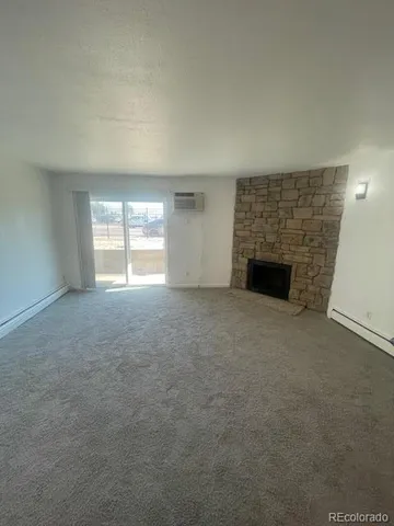 an empty room with a fireplace