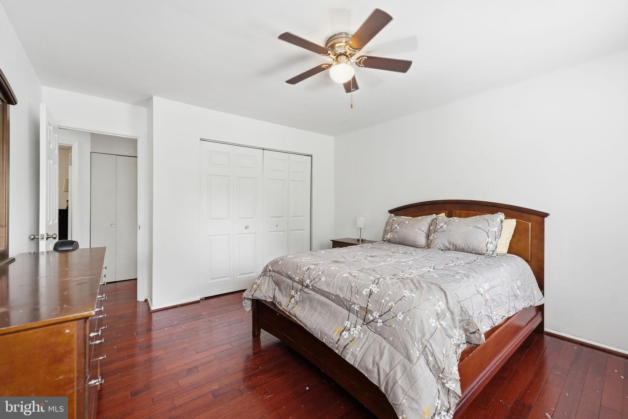 8260 Getty Court Springfield, VA 22153 - Photo 20 of 31 a bedroom with a bed and a chandelier