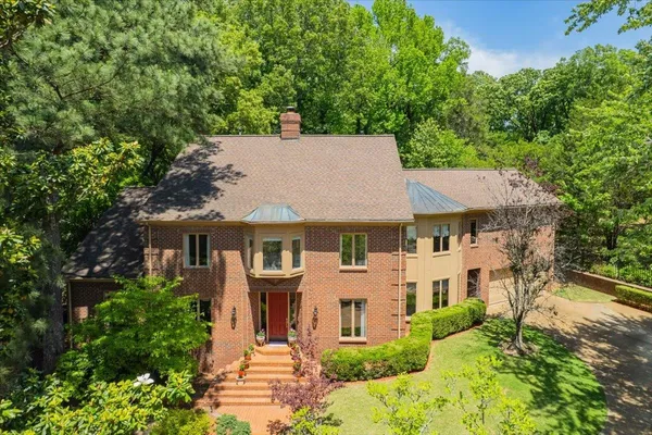 aerial view of a house with a yard and potted plants