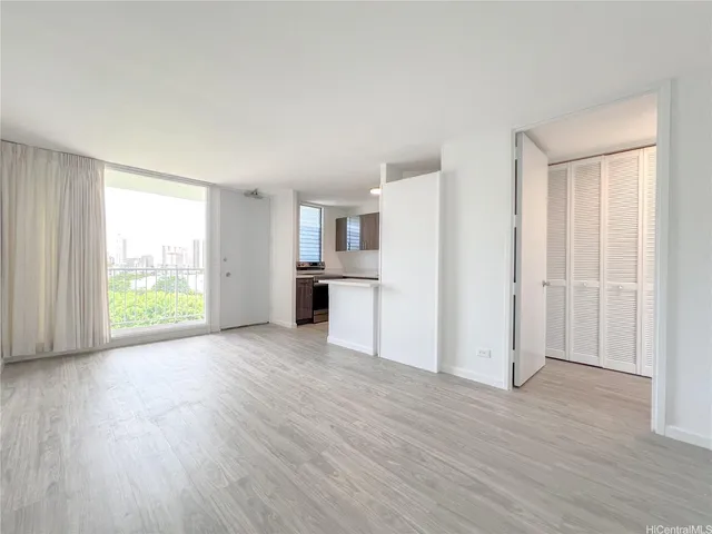 a kitchen with stainless steel appliances a sink cabinets and wooden floor