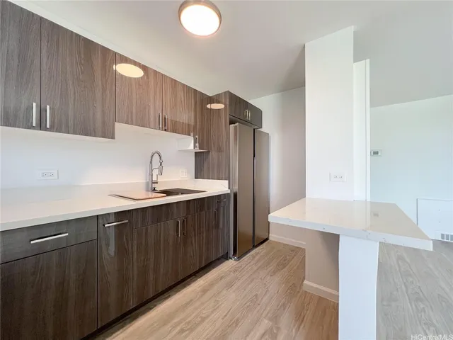 a kitchen with granite countertop a sink and a stove top oven