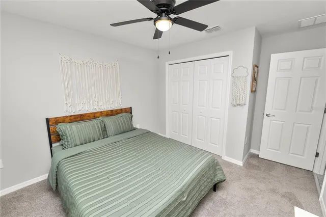 a bedroom with a bed and a ceiling fan