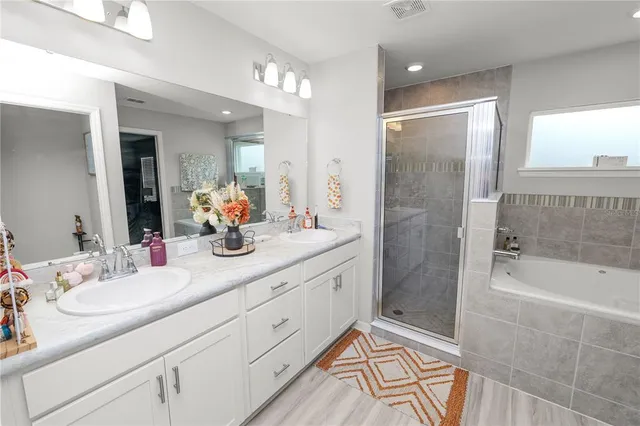 a bathroom with a granite countertop sink mirror and shower