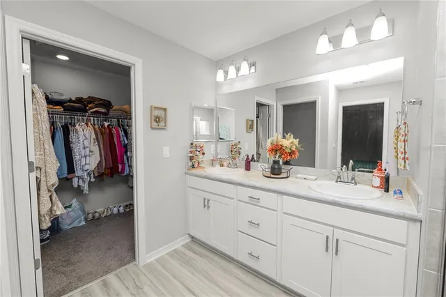 a bathroom with a double vanity sink and a mirror