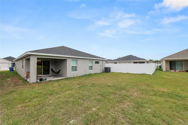 a view of a house with a yard and sitting area