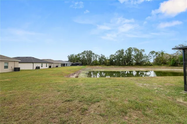 a view of a lake with houses in the back