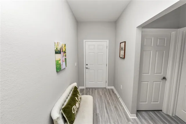 a view of a bedroom with wooden floor and closet