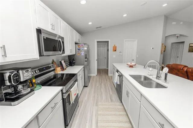 a kitchen with a sink and a stove top oven
