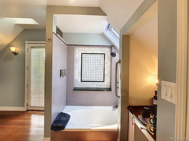 a bathroom with a bathtub and a shower