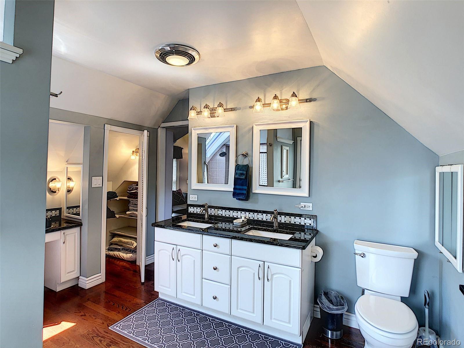 124 South Sherman Street, Unit UPSTAIRS Denver, CO 80209 - Photo 20 of 35 a spacious bathroom with a double vanity sink and a mirror