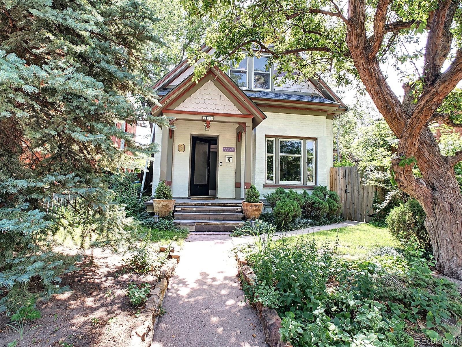 124 South Sherman Street, Unit UPSTAIRS Denver, CO 80209 - Photo 29 of 35 a front view of a house with yard and green space
