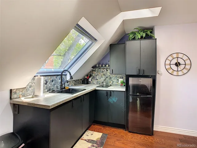 a kitchen with stainless steel appliances granite countertop a refrigerator and a sink