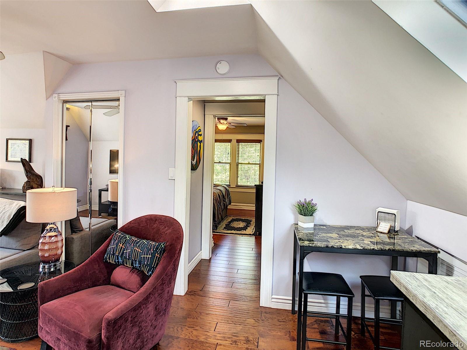 124 South Sherman Street, Unit UPSTAIRS Denver, CO 80209 - Photo 3 of 35 a living room with furniture and a wooden floor