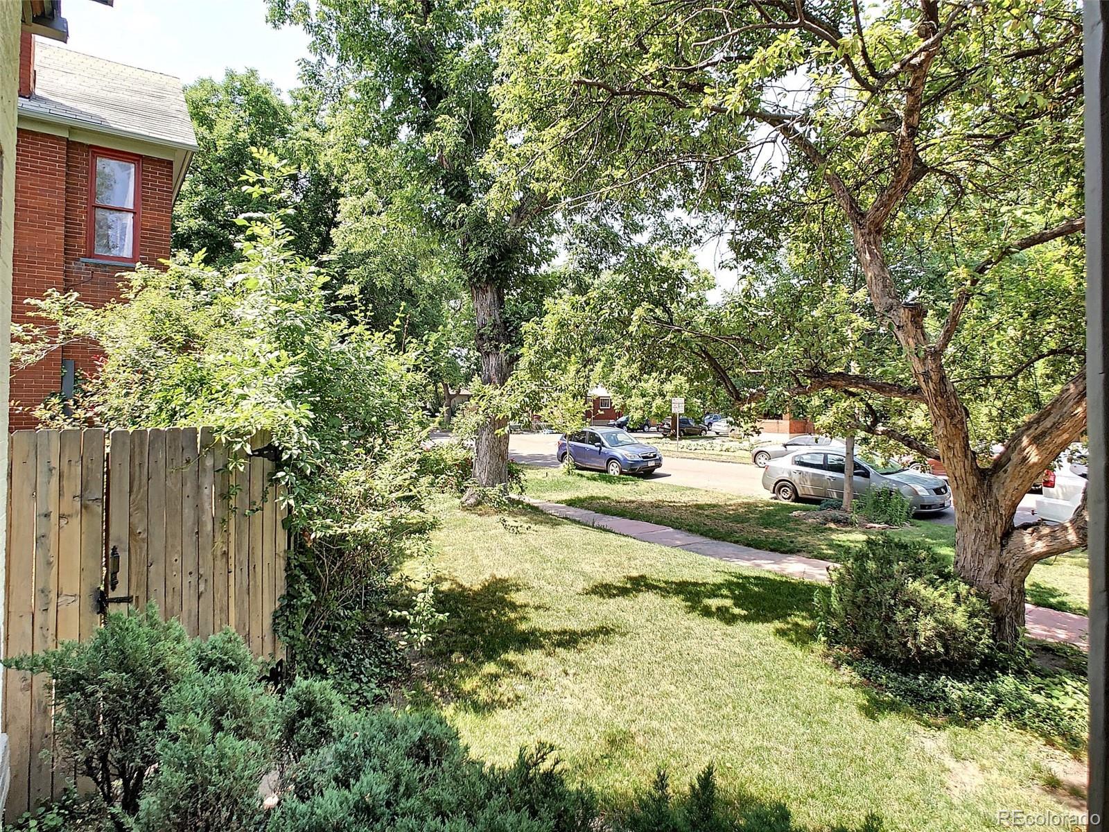 124 South Sherman Street, Unit UPSTAIRS Denver, CO 80209 - Photo 33 of 35 a view of backyard of house with trees