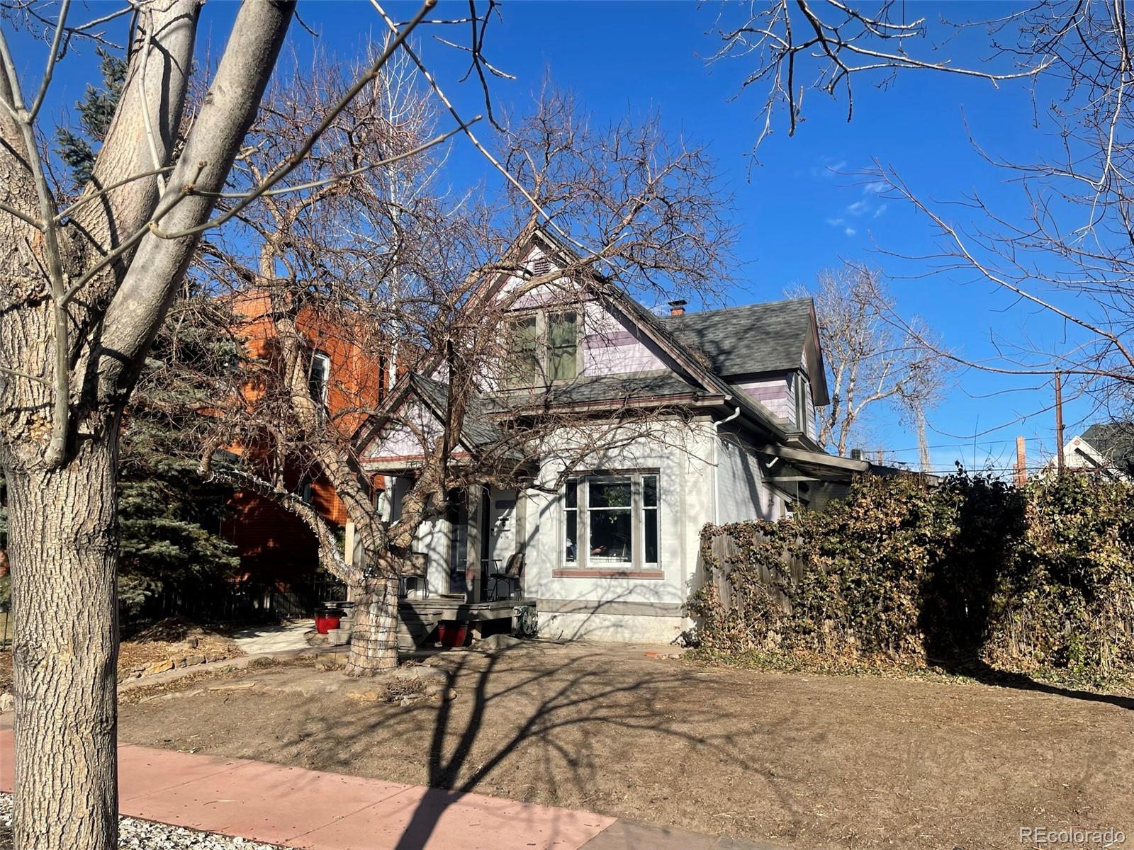 124 South Sherman Street, Unit UPSTAIRS Denver, CO 80209 - Photo 35 of 35 a view of a white house with a large tree