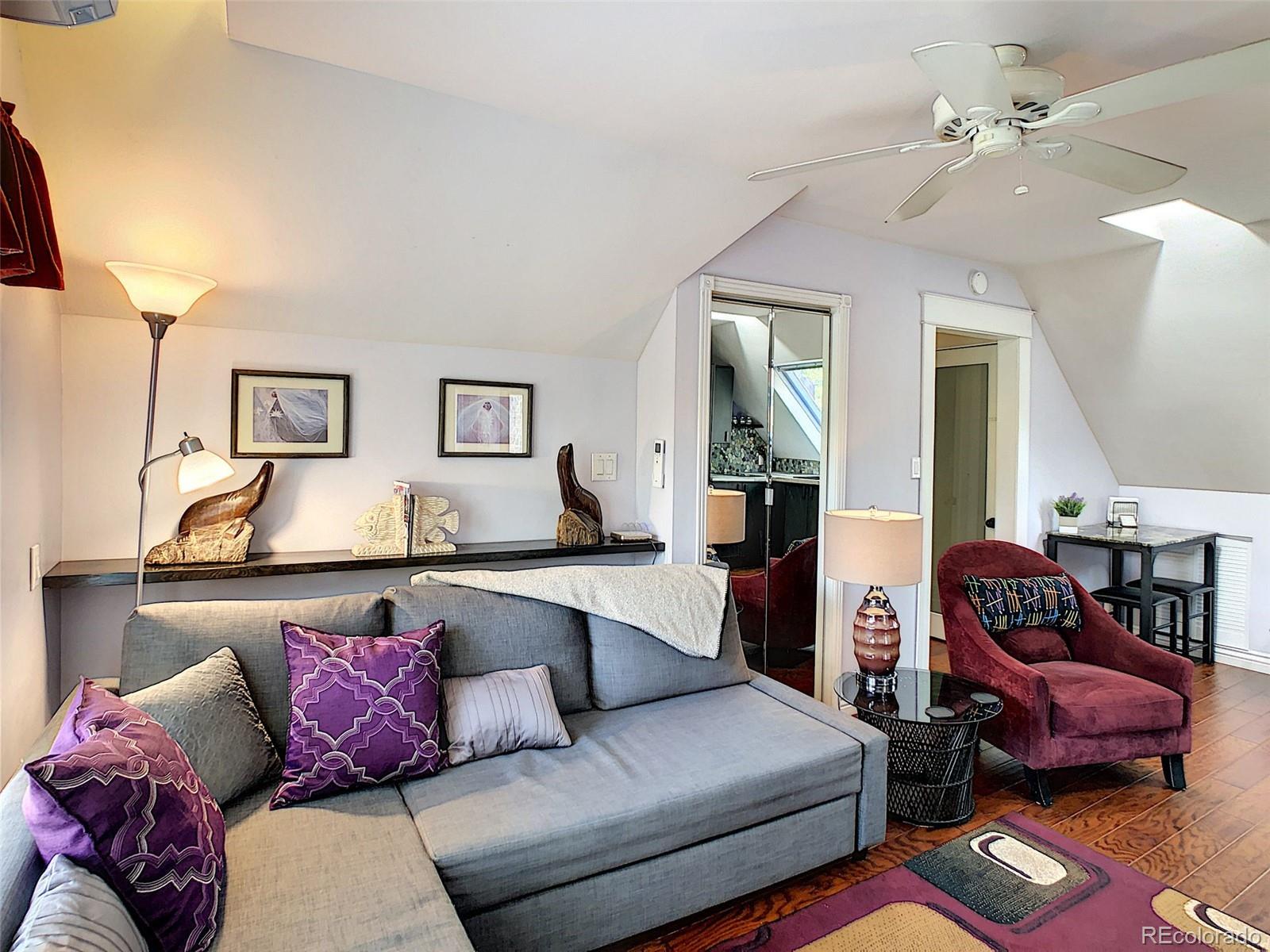 124 South Sherman Street, Unit UPSTAIRS Denver, CO 80209 - Photo 7 of 35 a living room with furniture and a couch