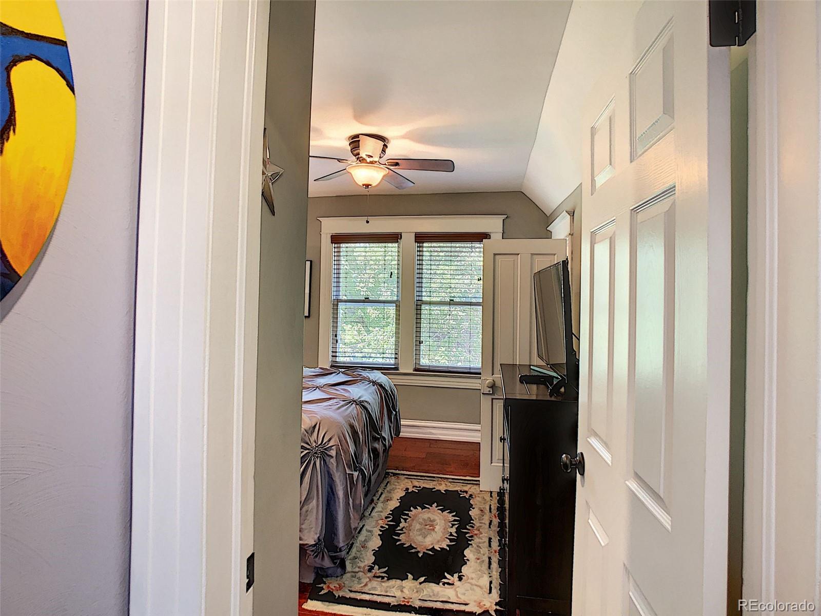 124 South Sherman Street, Unit UPSTAIRS Denver, CO 80209 - Photo 8 of 35 a bedroom with a bed and a window