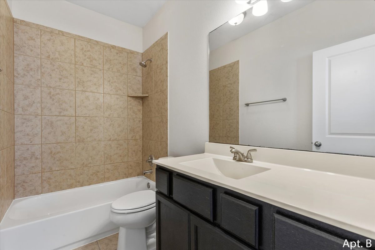 2225 Katy Lane, Unit B Georgetown, TX 78626 - Photo 16 of 22 Bathroom featuring vanity, shower / bathtub combination, and light tile patterned floors