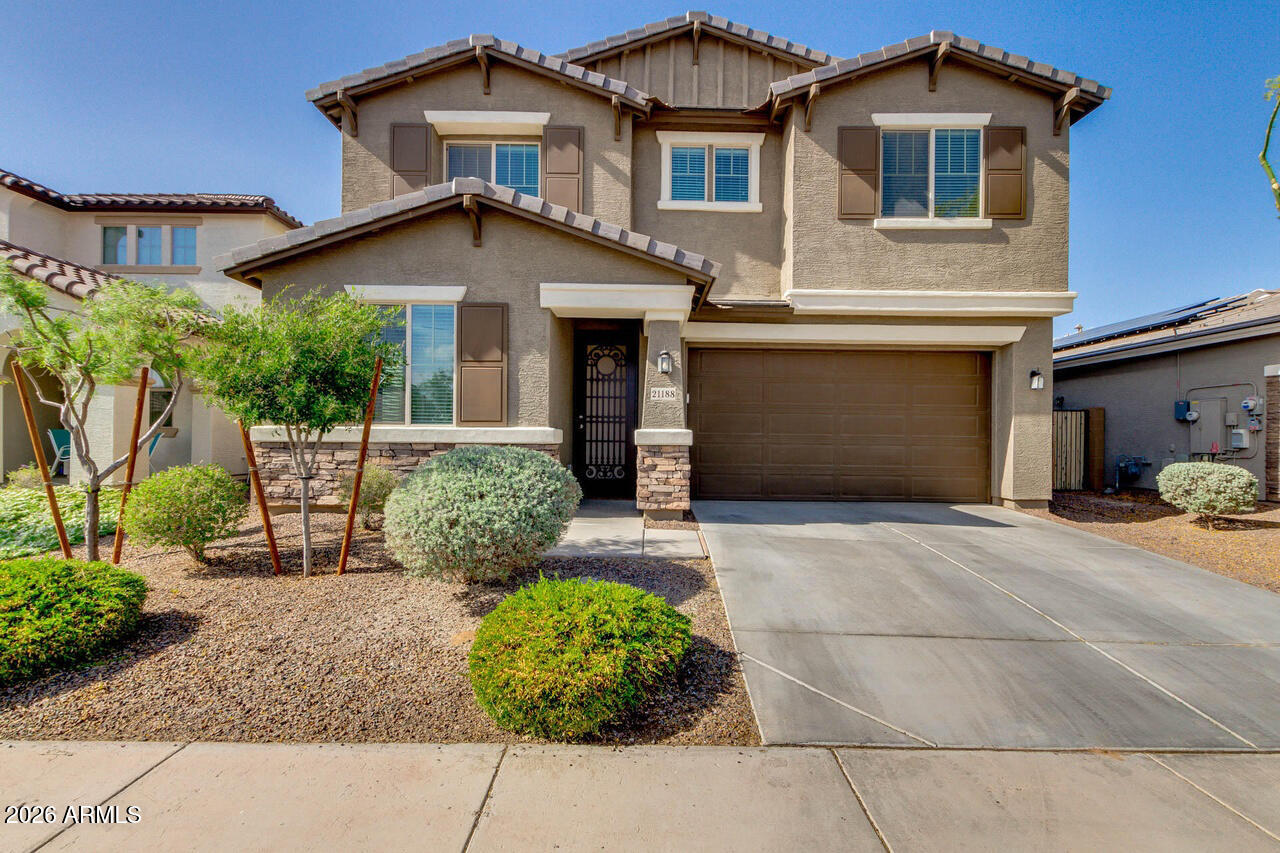 21188 West Almeria Road Buckeye, AZ 85396 - Photo 1 of 43 a front view of a house with garden