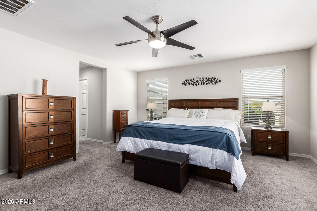 21188 West Almeria Road Buckeye, AZ 85396 - Photo 11 of 43 a bedroom with a bed and window