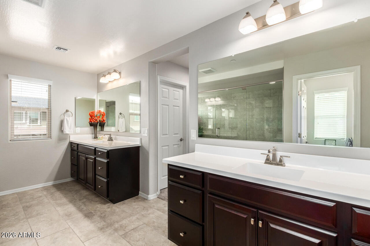 21188 West Almeria Road Buckeye, AZ 85396 - Photo 17 of 43 a bathroom with a sink double vanity and a mirror