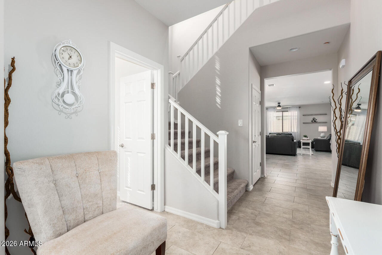 21188 West Almeria Road Buckeye, AZ 85396 - Photo 27 of 43 a living room with furniture and a wooden floor