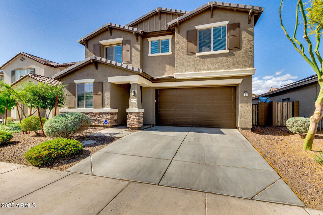 21188 West Almeria Road Buckeye, AZ 85396 - Photo 29 of 43 a front view of a house with yard