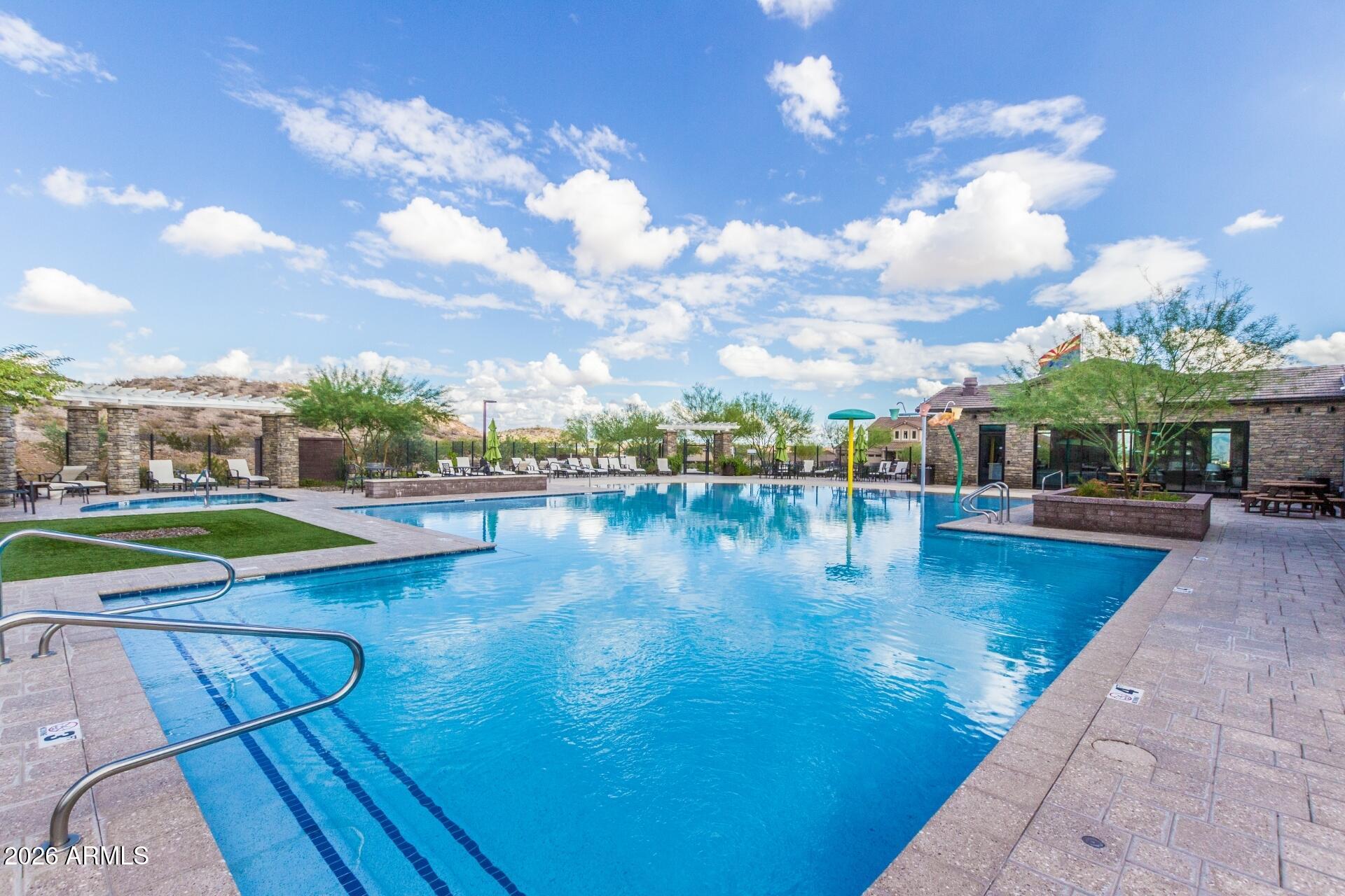 21188 West Almeria Road Buckeye, AZ 85396 - Photo 31 of 43 a view of a swimming pool with an outdoor seating