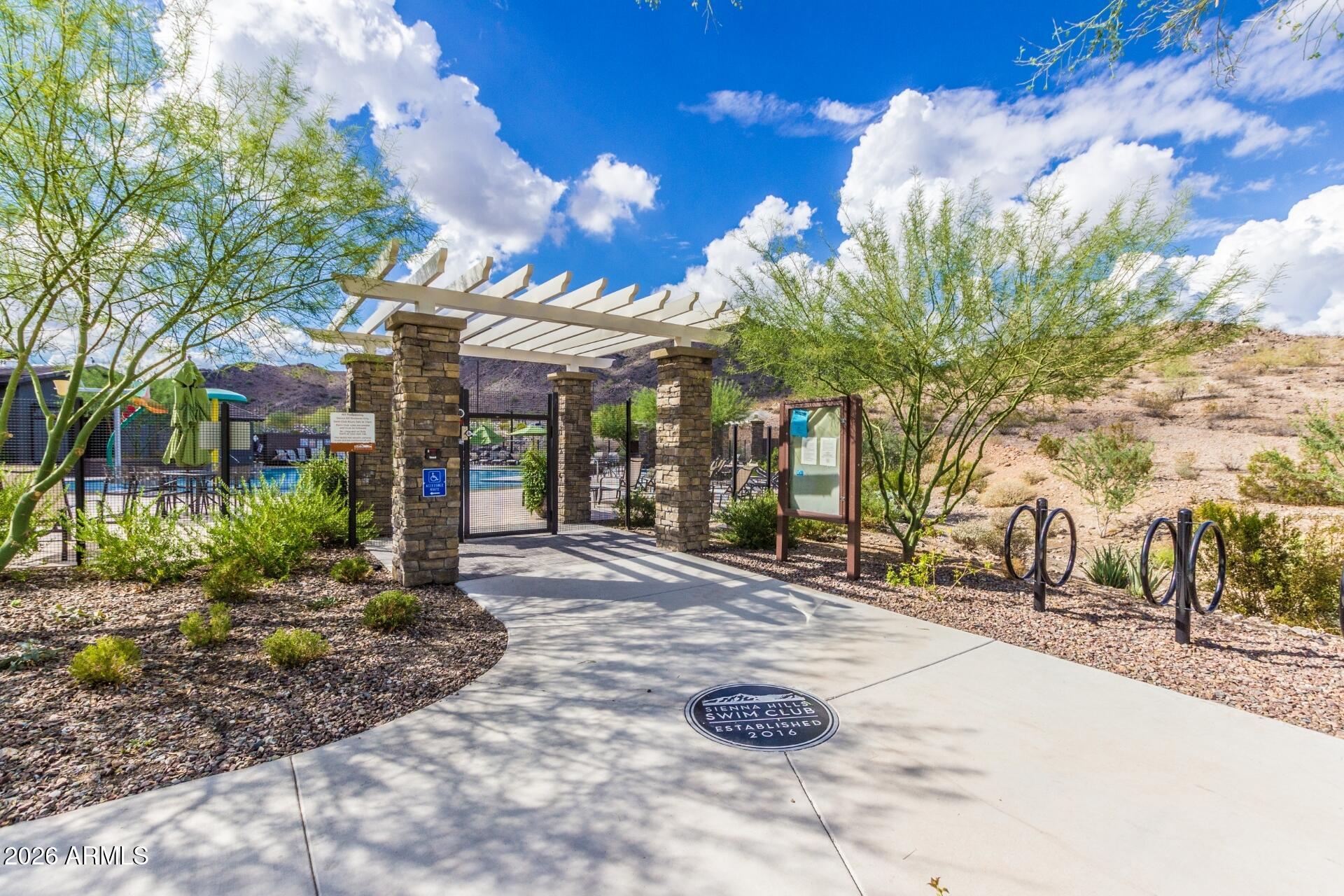 21188 West Almeria Road Buckeye, AZ 85396 - Photo 35 of 43 a view of a white house with a yard