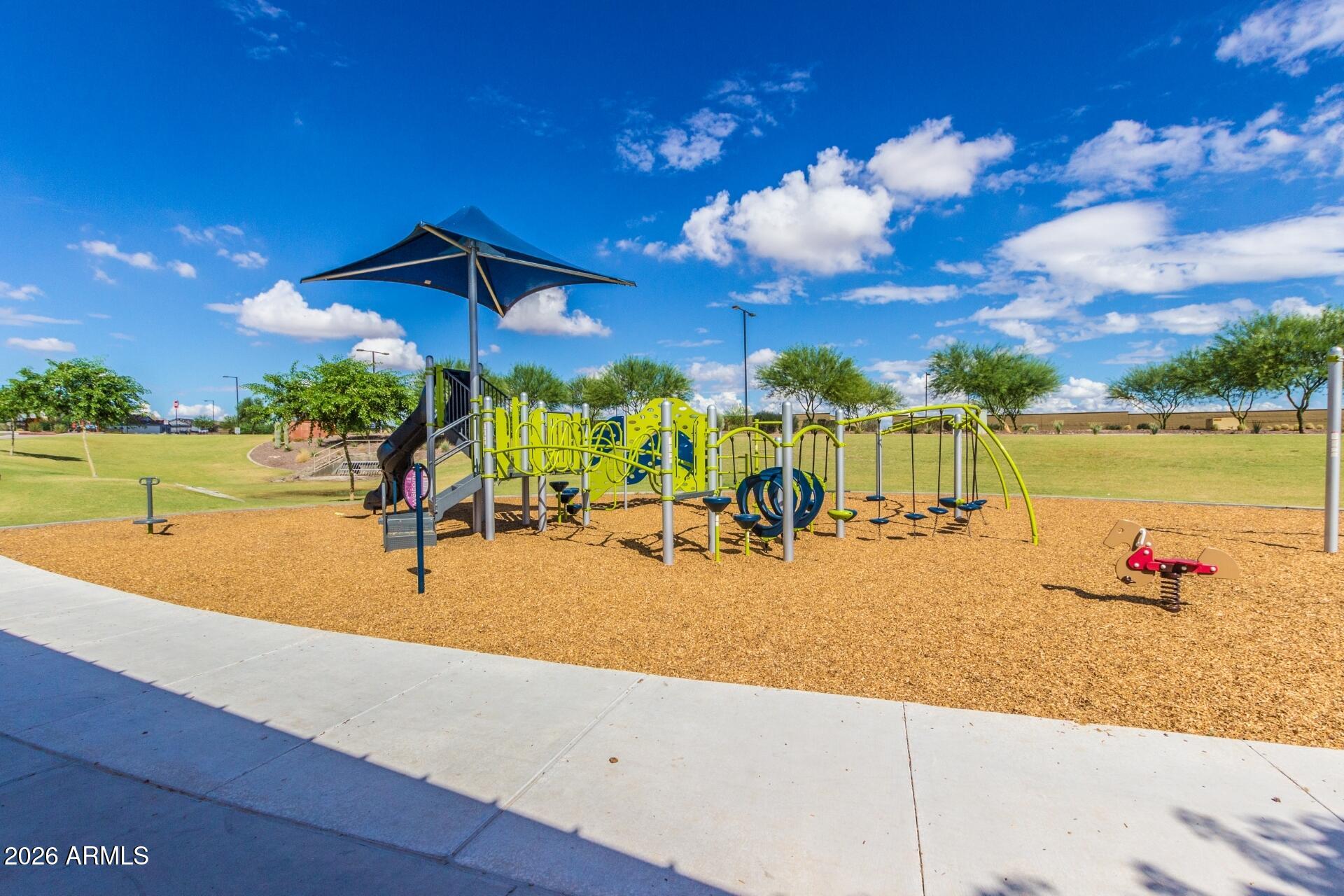 21188 West Almeria Road Buckeye, AZ 85396 - Photo 36 of 43 a view of a swimming pool with a lounge chairs