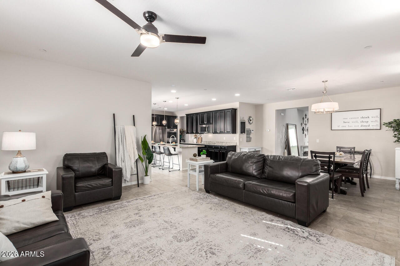 21188 West Almeria Road Buckeye, AZ 85396 - Photo 8 of 43 a living room with furniture and a ceiling fan