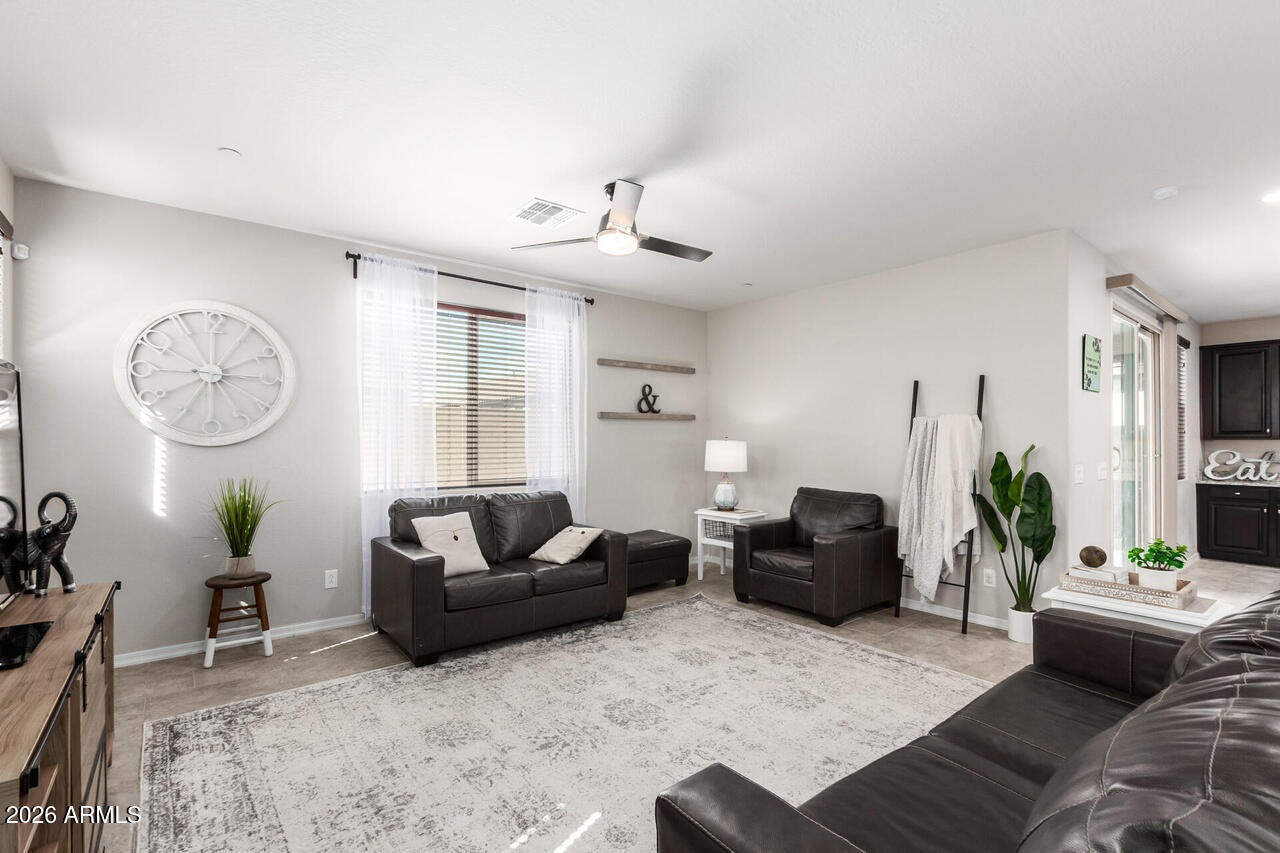 21188 West Almeria Road Buckeye, AZ 85396 - Photo 9 of 43 a living room with furniture and a large window