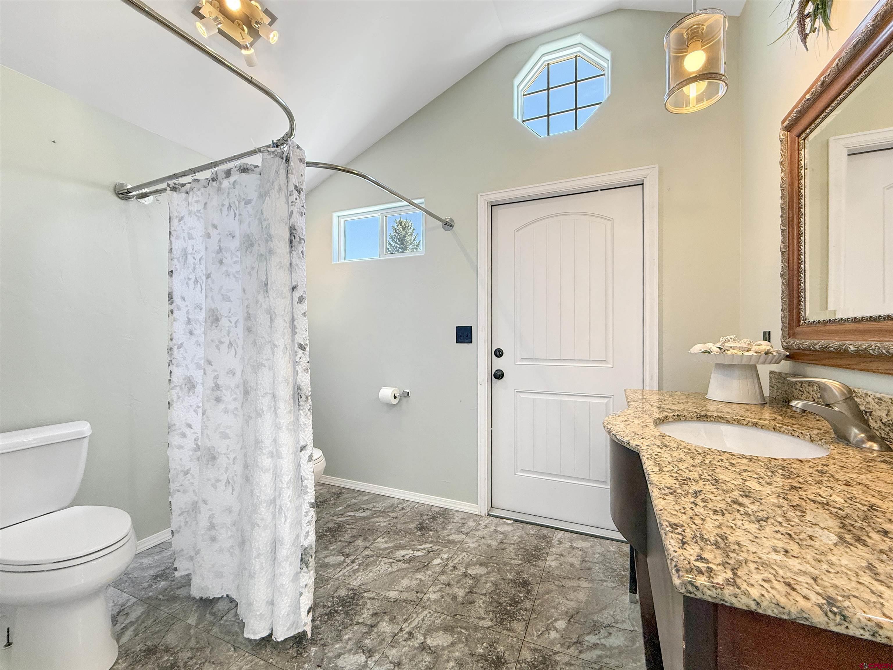 5955 Sawmill Mesa Road Delta, CO 81416 - Photo 28 of 32 a bathroom with a granite countertop sink toilet and shower