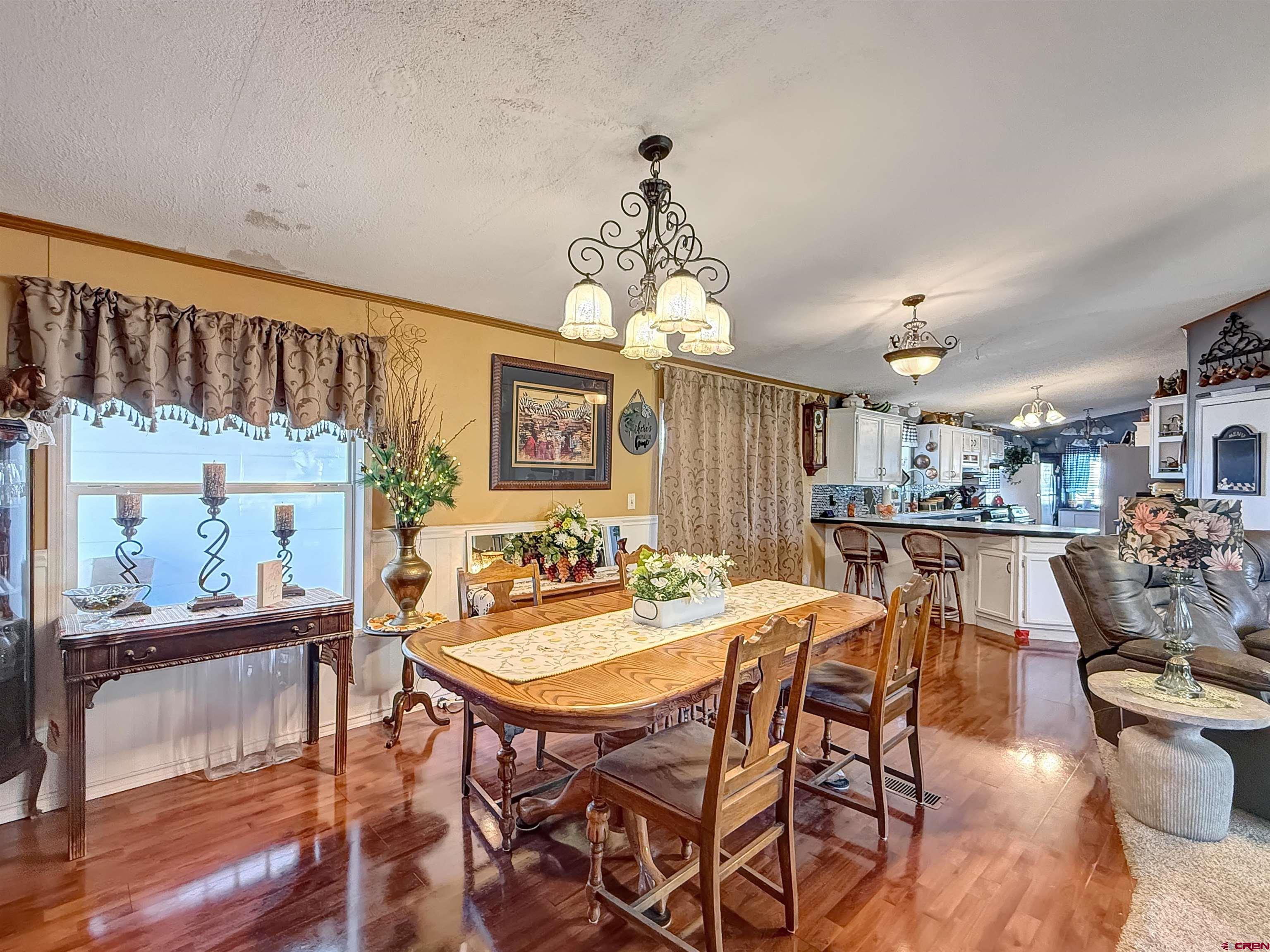 5955 Sawmill Mesa Road Delta, CO 81416 - Photo 3 of 32 a view of a dining room with furniture and wooden floor