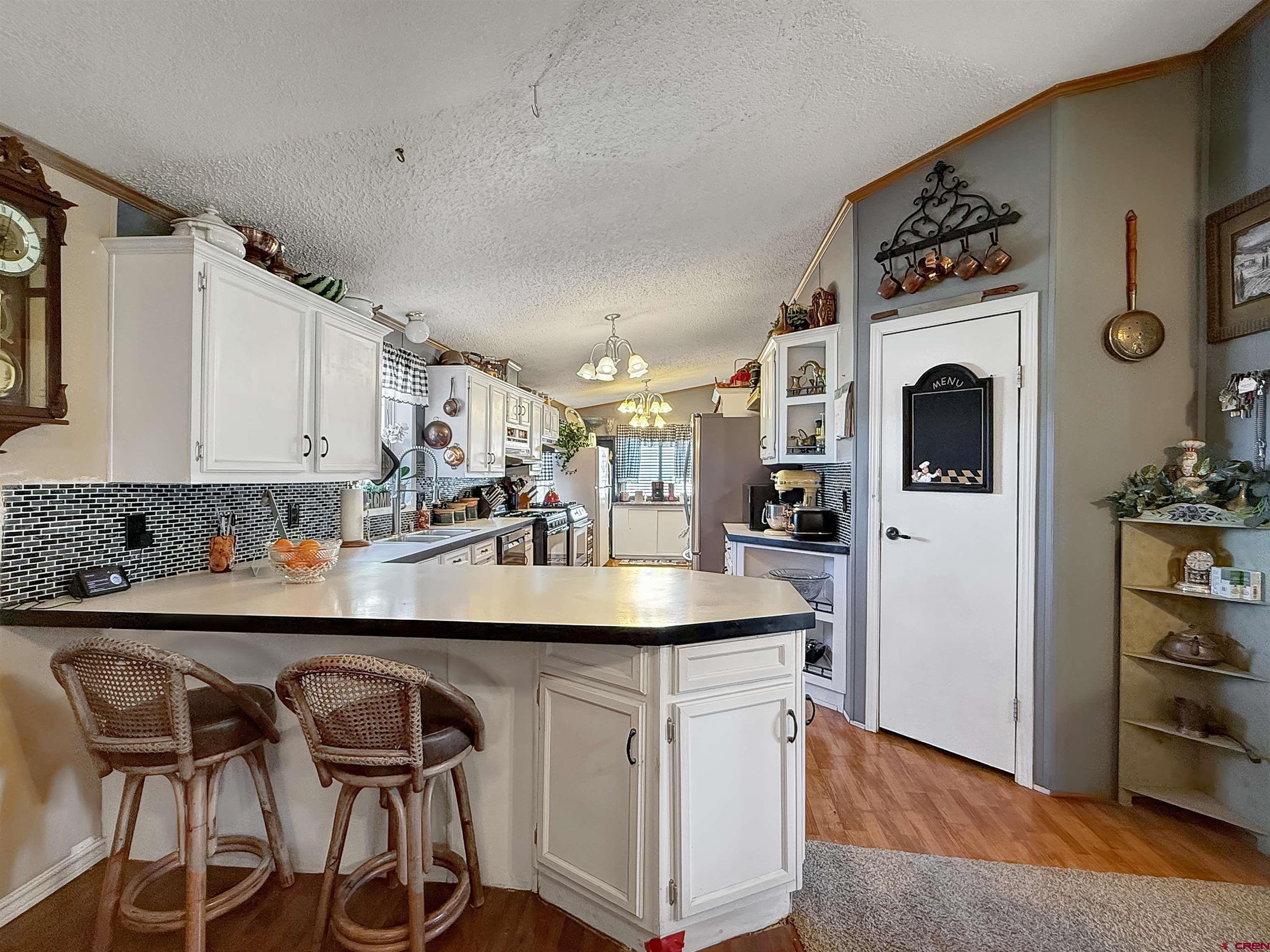 5955 Sawmill Mesa Road Delta, CO 81416 - Photo 5 of 32 a kitchen with stainless steel appliances granite countertop a sink and a refrigerator