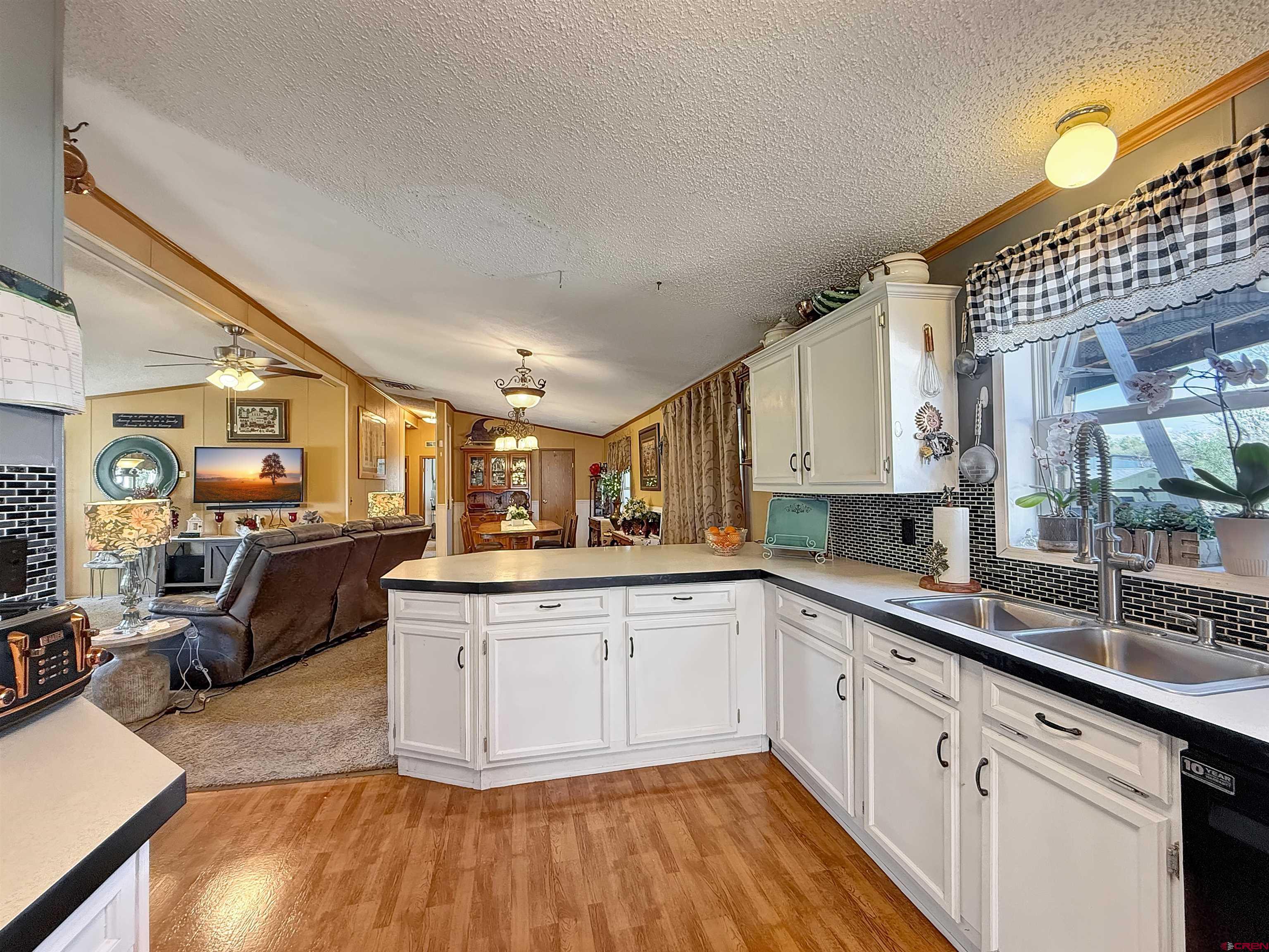 5955 Sawmill Mesa Road Delta, CO 81416 - Photo 6 of 32 a kitchen with cabinets a sink and appliances