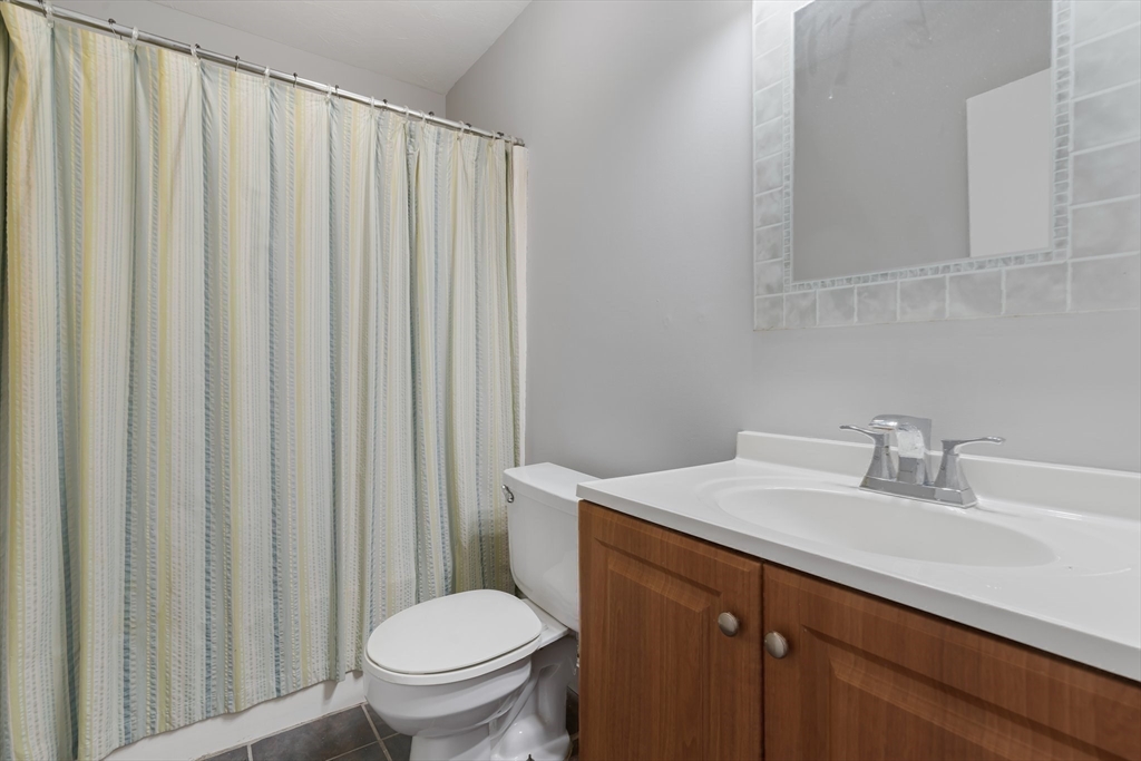 46 Gibbs Street, Unit 4D Worcester, MA 01607 - Photo 15 of 21 a bathroom with a sink a toilet and a mirror