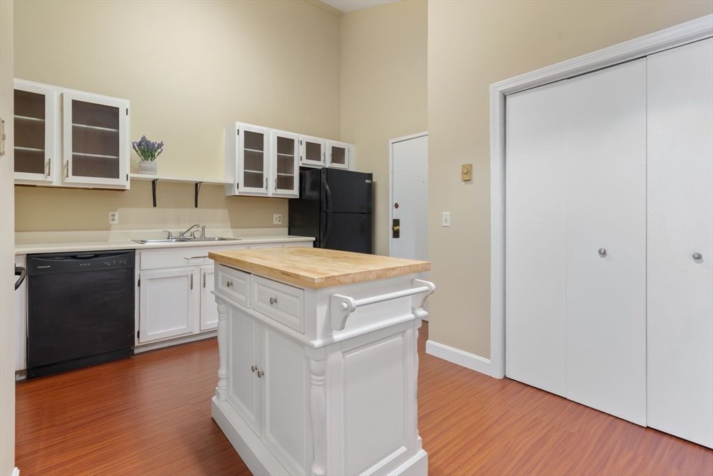 46 Gibbs Street, Unit 4D Worcester, MA 01607 - Photo 5 of 21 a kitchen with a stove top oven and cabinets