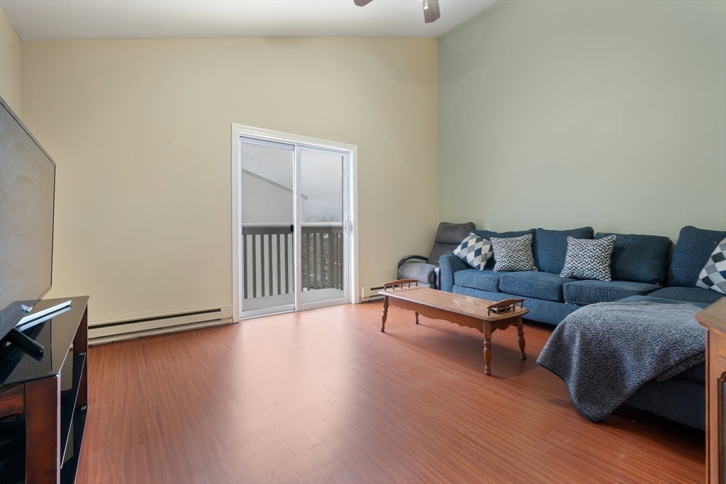 46 Gibbs Street, Unit 4D Worcester, MA 01607 - Photo 9 of 21 a living room with furniture and a wooden floor