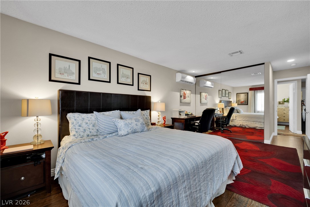 530 Grape Drive Henderson, NV 89015 - Photo 24 of 39 Hardwood floors and sleek mirrored walls define this inviting and comfortable bedroom space.