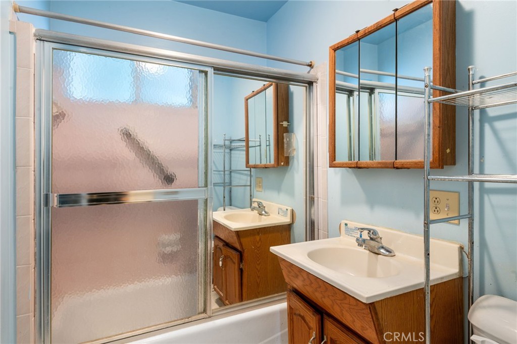 12128 161st Street Norwalk, CA 90650 - Photo 14 of 18 a bathroom with a sink and mirror