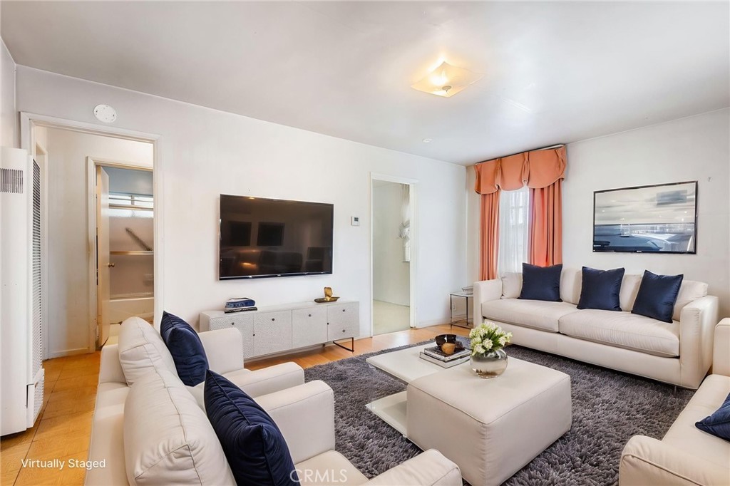 12128 161st Street Norwalk, CA 90650 - Photo 4 of 18 a living room with furniture flat screen tv and a large window