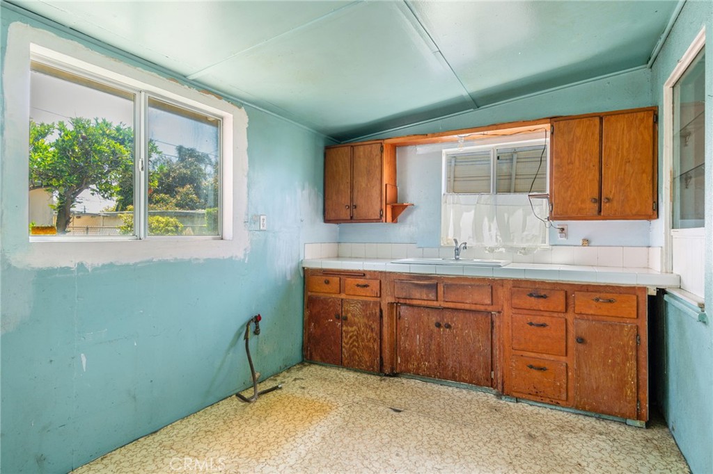 12128 161st Street Norwalk, CA 90650 - Photo 9 of 18 a spacious bathroom with a granite countertop sink and a window