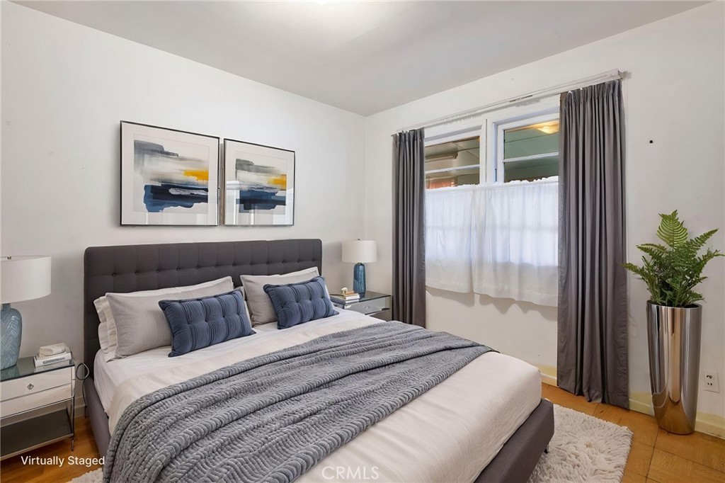 12128 161st Street Norwalk, CA 90650 - Photo 10 of 18 a bedroom with a large bed and a potted plant