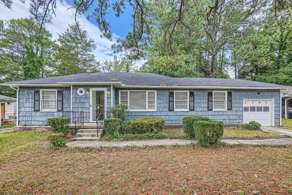 a front view of a house with garden and porch