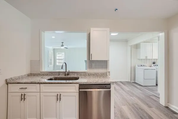 a kitchen with a sink stove and cabinets