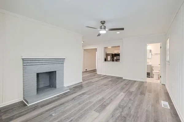 wooden floor fireplace and windows in an empty room
