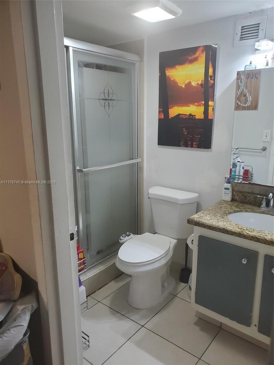 17021 North Bay Road, Unit 329 Sunny Isles Beach, FL 33160 - Photo 17 of 18 a bathroom with a toilet sink and mirror