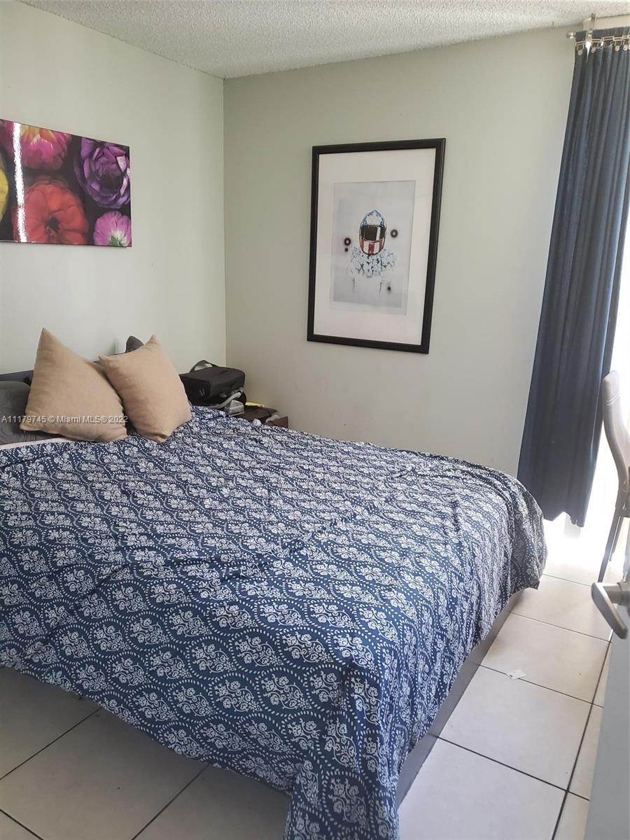 17021 North Bay Road, Unit 329 Sunny Isles Beach, FL 33160 - Photo 18 of 18 a bedroom with a bed and a window