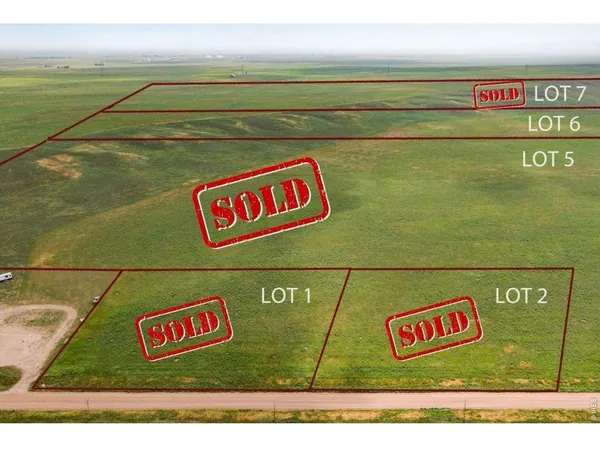 a street sign on a wall next to a road